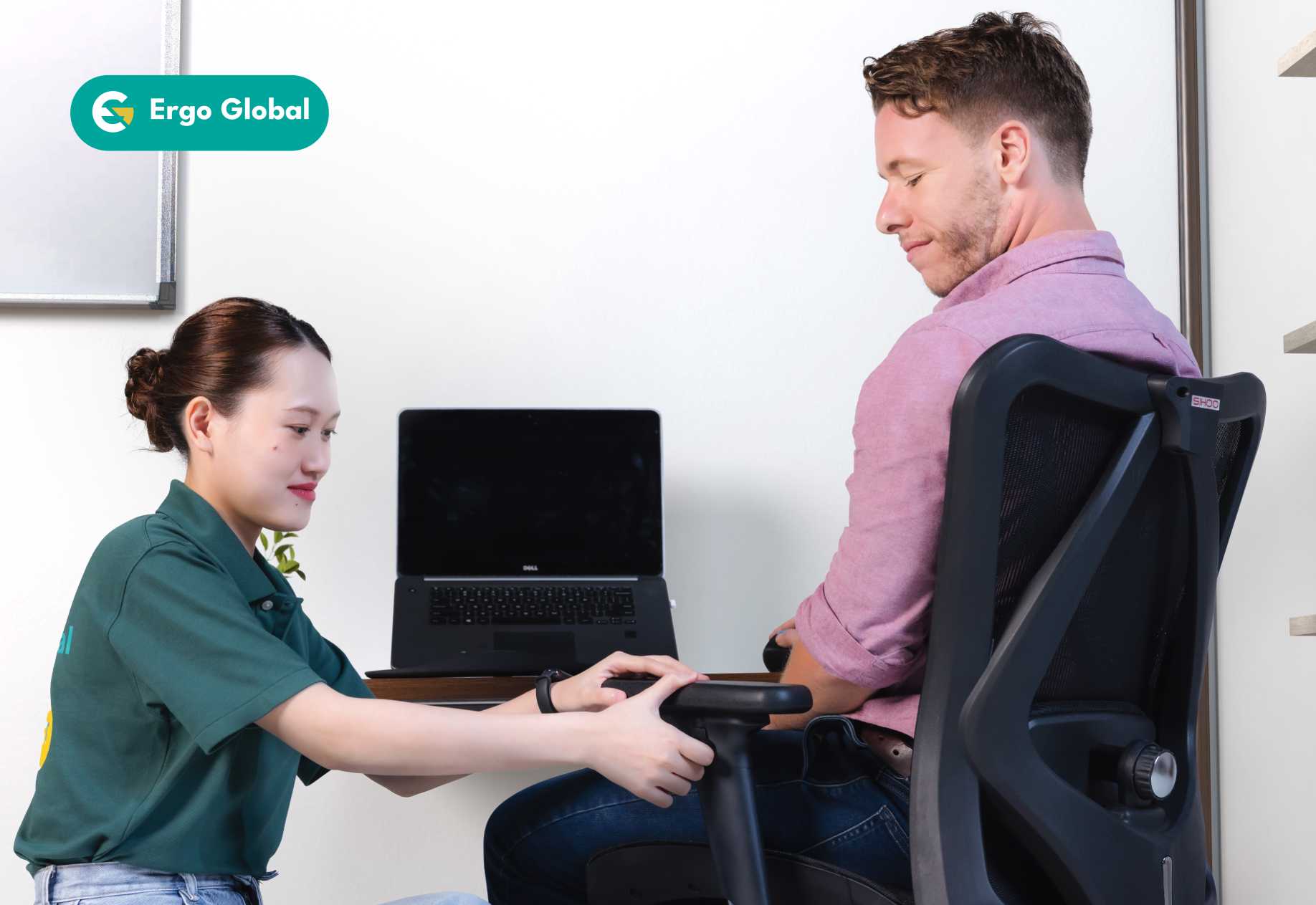 An ergonomist adjusting a chair for an employee