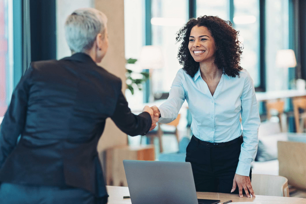 Two people shaking hands as the lady returns to work