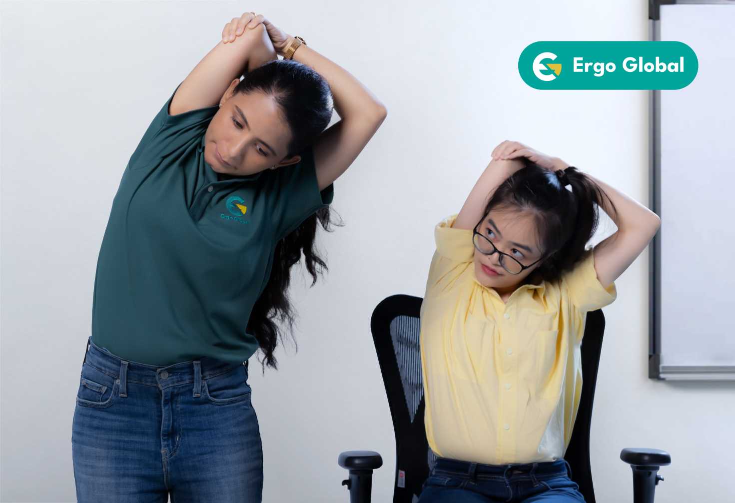 Ergonomist showing an employee how to stretch her back