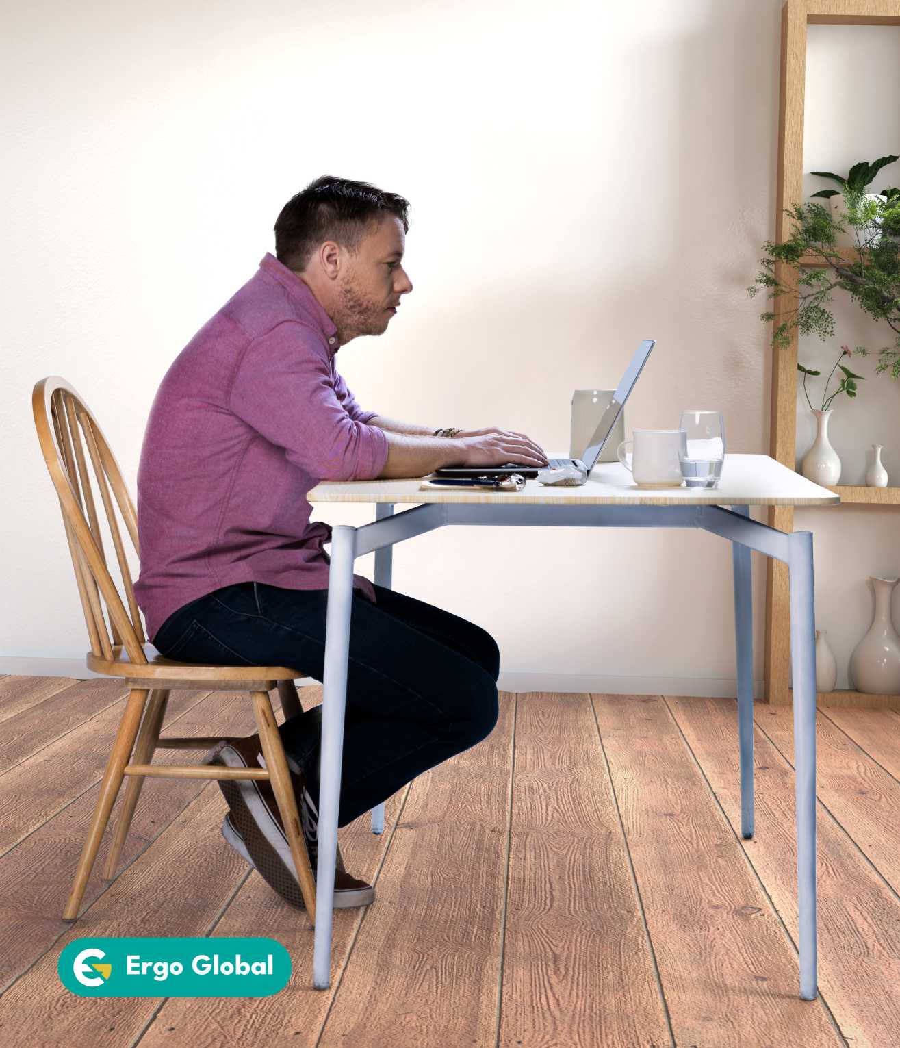 man working slouched at his desk due to sedentary lifestyle
