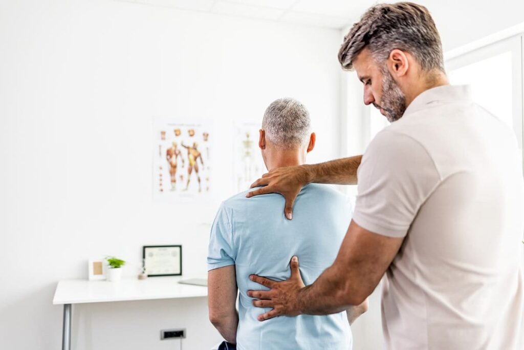 man with back pain from work gets therapy