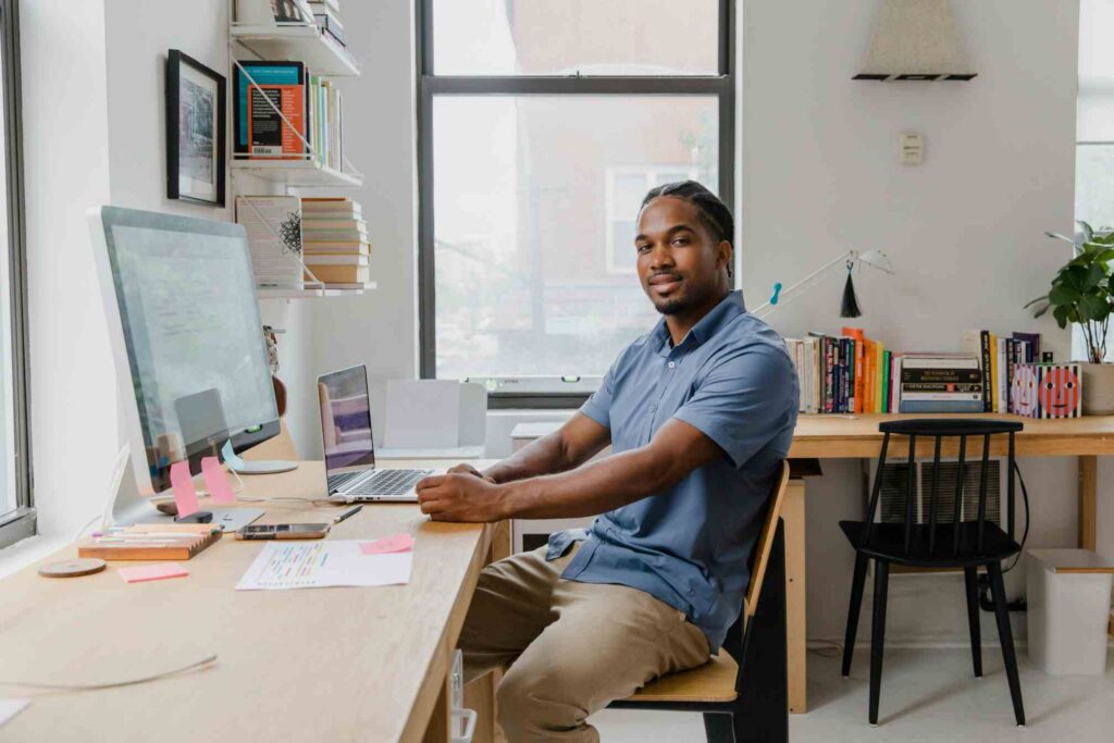 Man performing a self-assessment checklist for ergonomics at desk
