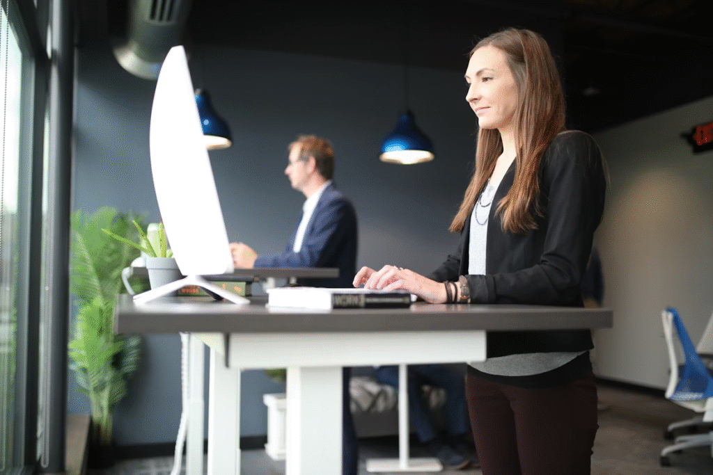 Two employees standing at two different standing desks