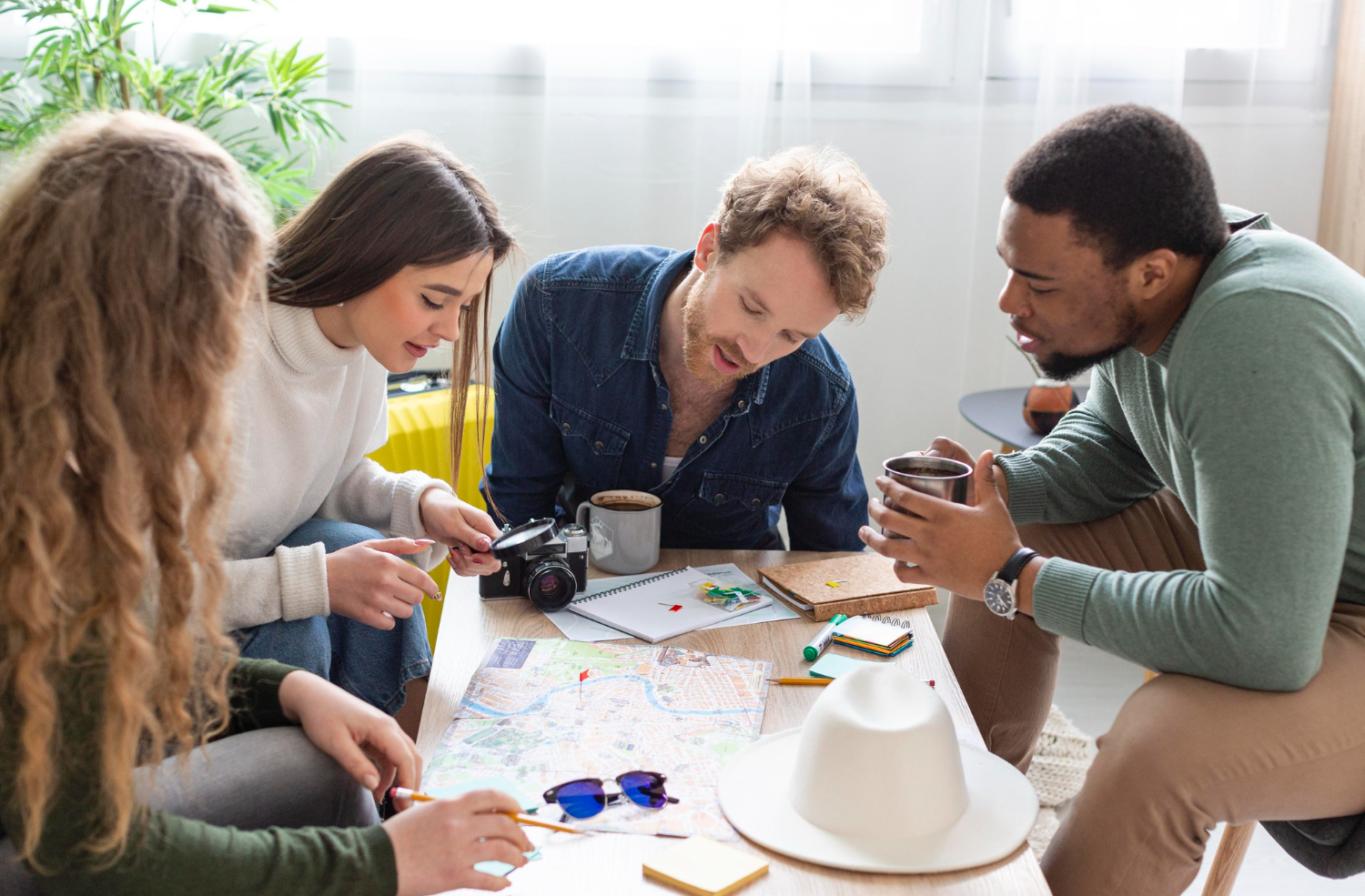 A diverse team collaborating effectively around a large table, illustrating good organizational ergonomics in practice.