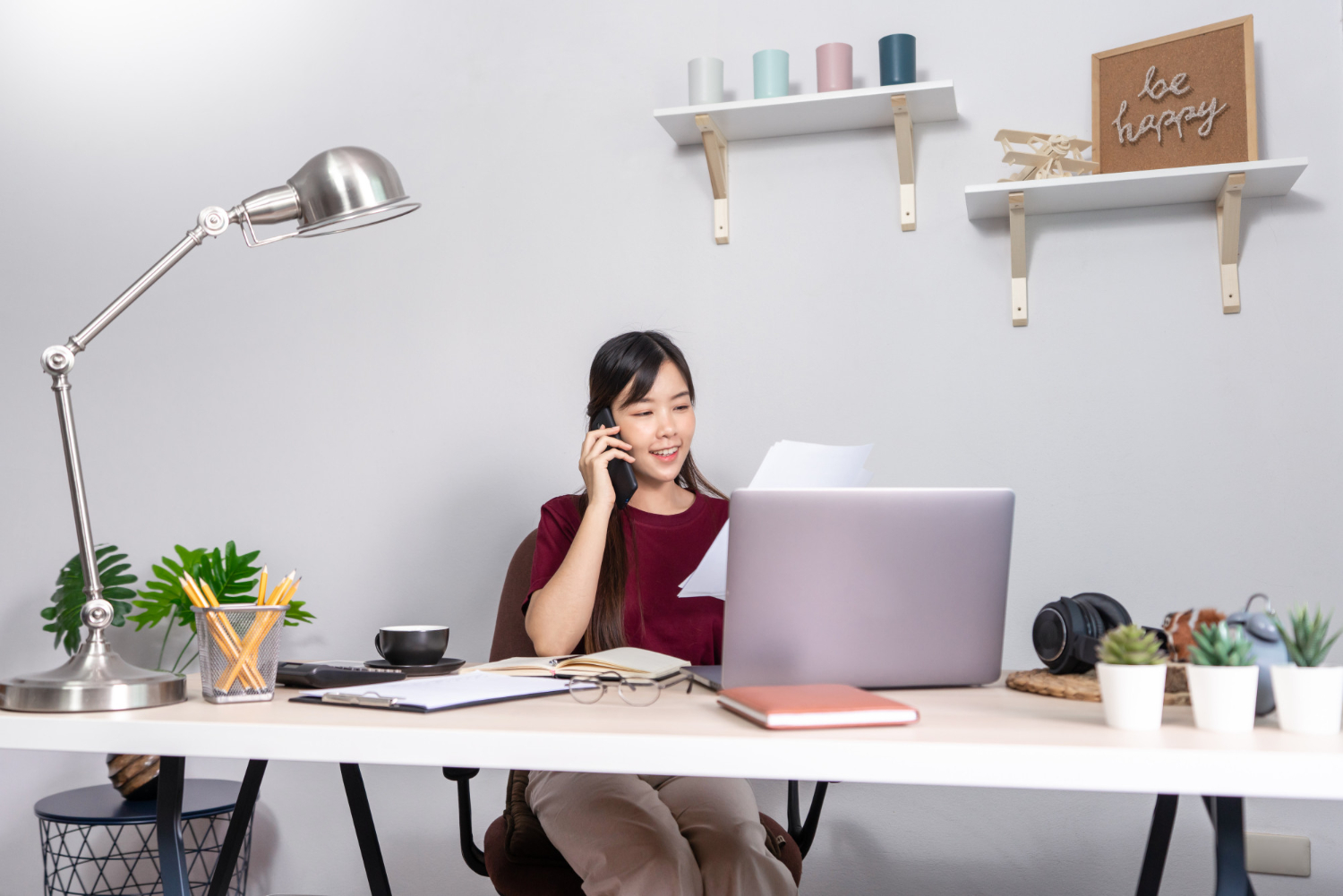 Person comfortably working at an organized desk, illustrating what is office ergonomics.