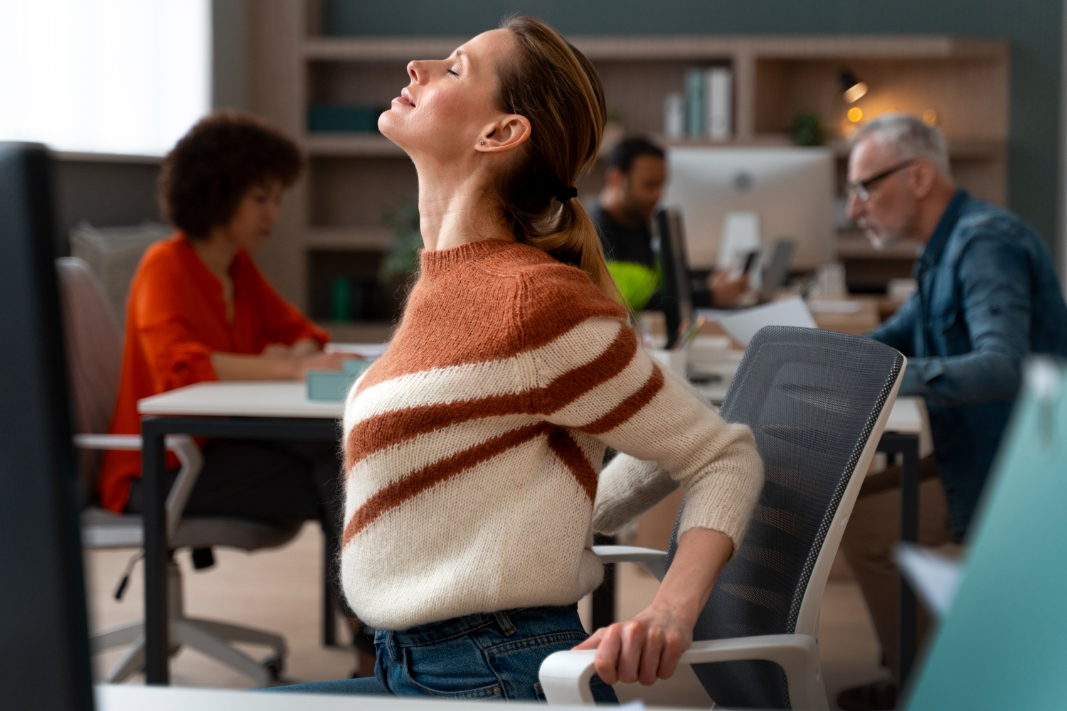 Happy employees working productively in a modern, ergonomically designed office.