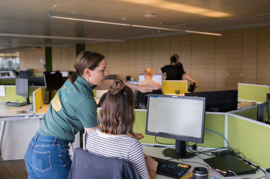 Ergonomic consultant observing an office employee's posture.