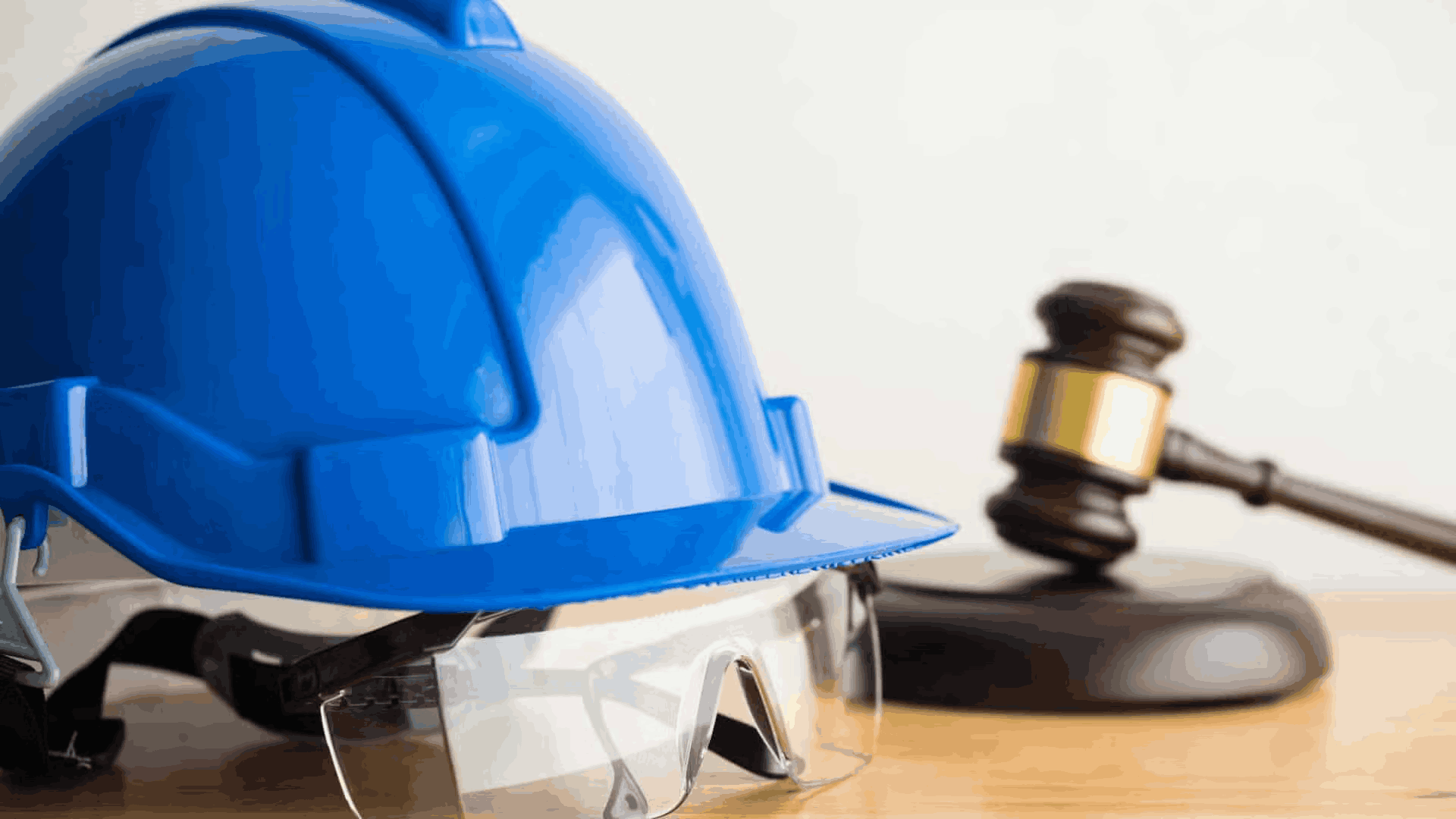 A hard hat and gavel, representing one of the 5 countries with the highest penalties for workplace noncompliance