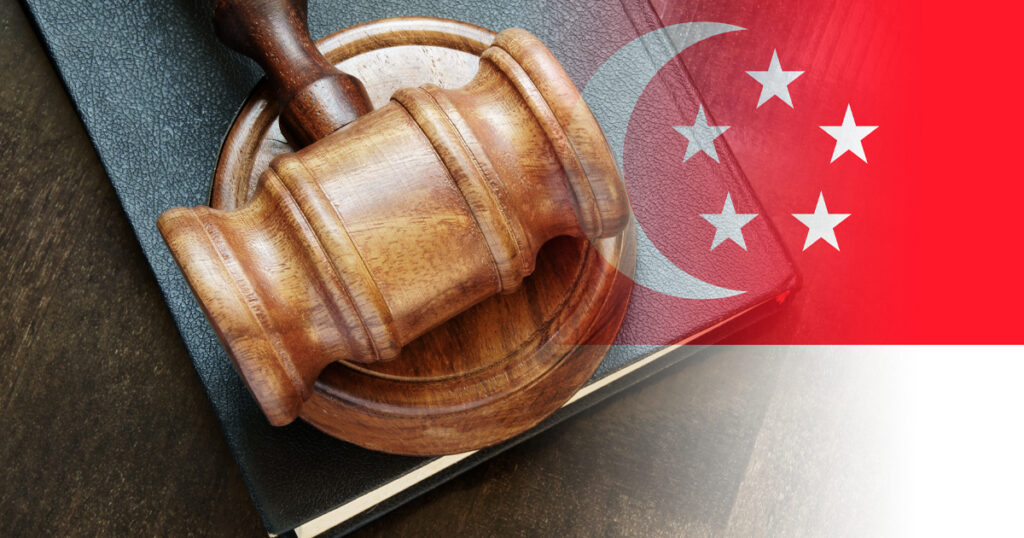 A gavel and a Singapore flag
