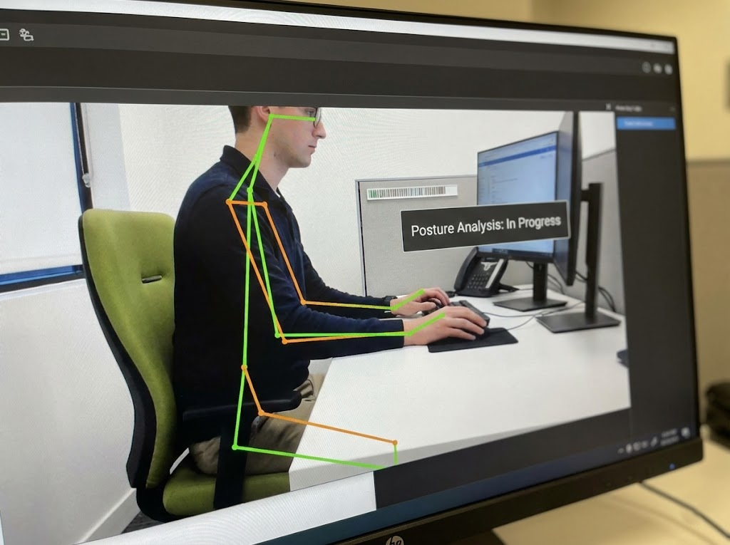 A computer screen displaying a posture analysis with a digital skeletal overlay.