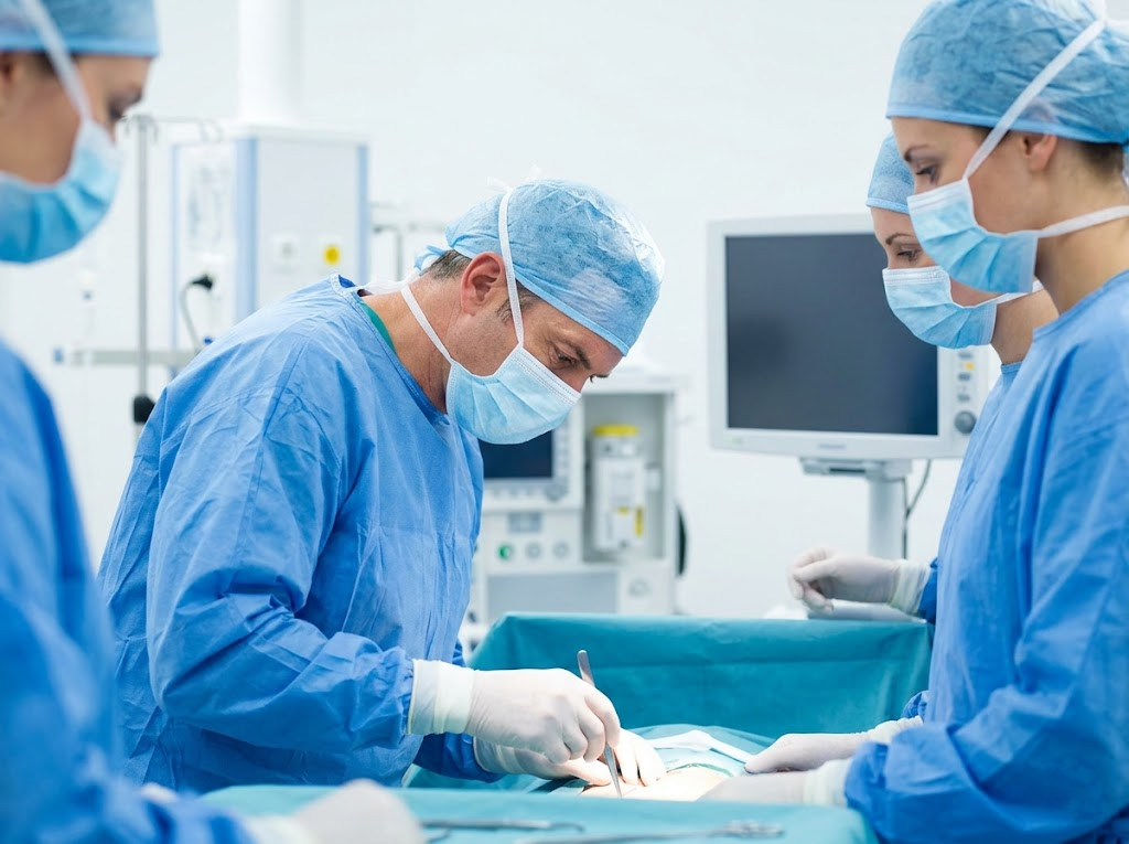 Surgical team performing procedure in an operating room.